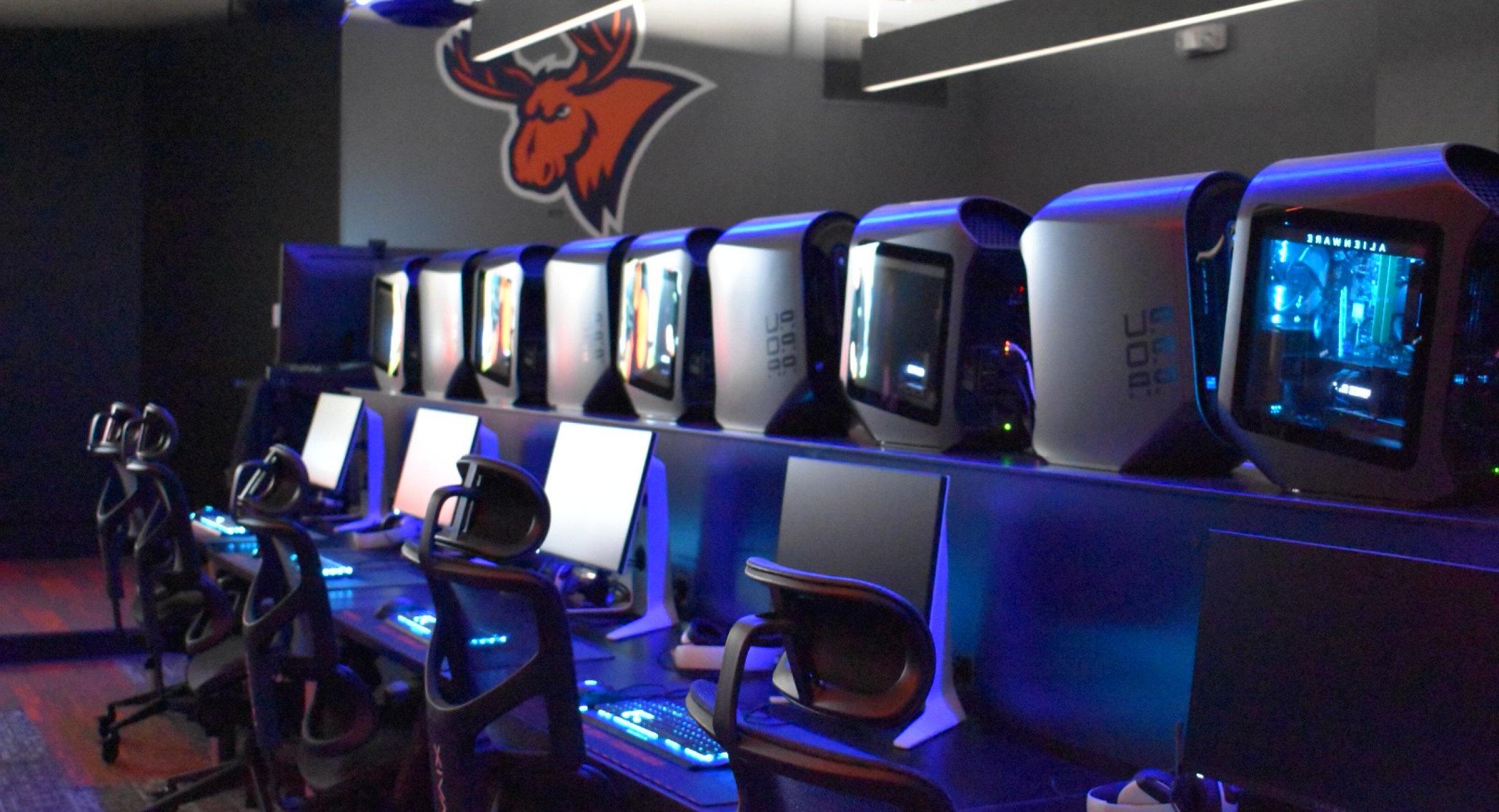 A row of seats and computers in the all-new eSports auditorium.