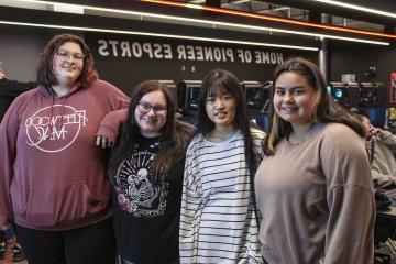 The four members of the first all-female eSports team at 利记sbo stands shoulder to shouler.